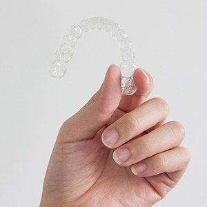 Patient holding clear aligner