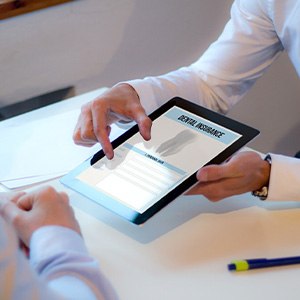 Patient reviewing dental insurance form on tablet