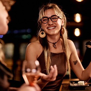 Friends smiling while enjoying meal together