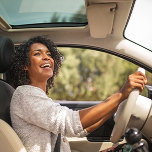 Woman smiling while driving
