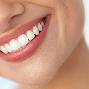 Nose-to-neck closeup of woman’s smile