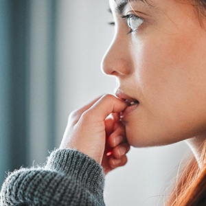 Closeup of woman biting her nails